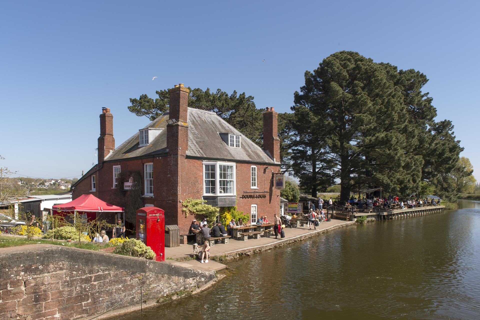 a brick building next to a river