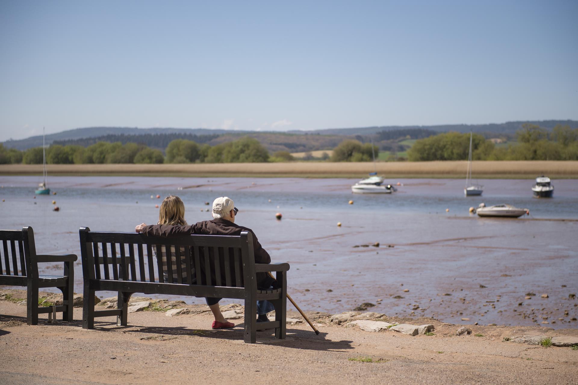 a couple sits on a bench