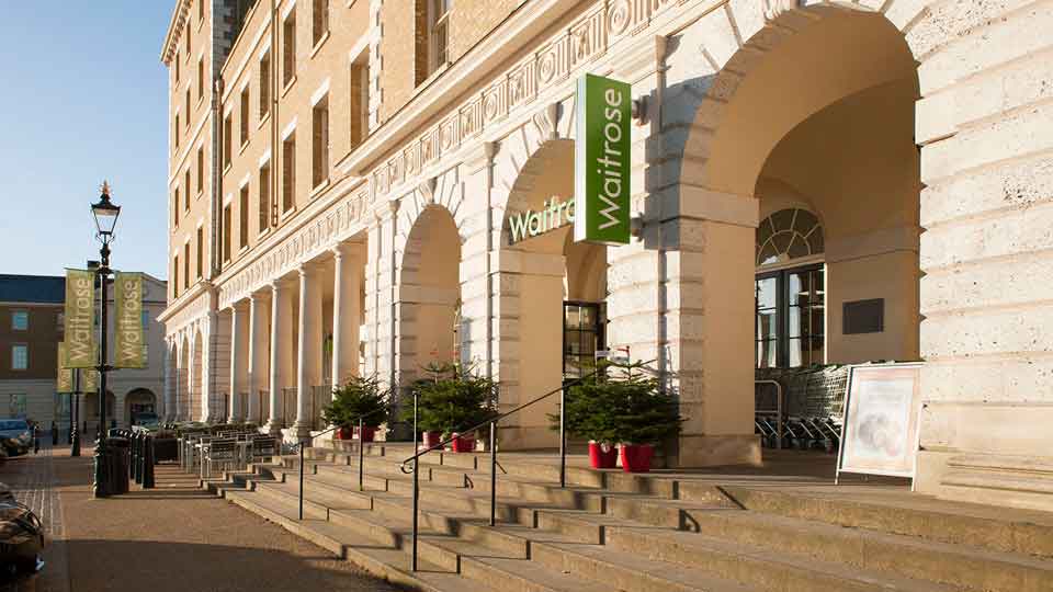 a large stone building with a green sign on the front