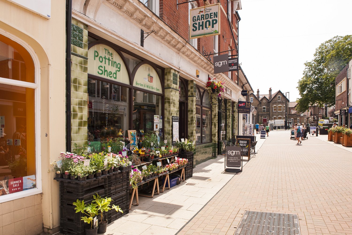 Terraced exterior of a garden shop and other stores in Dorchester town centre.