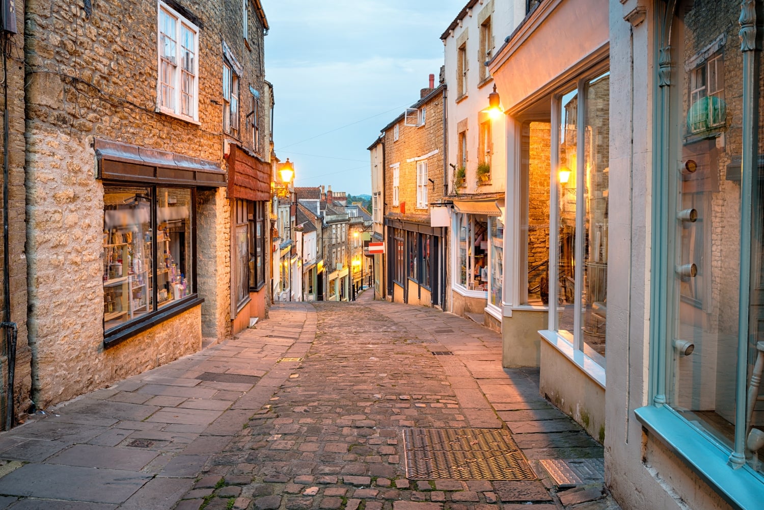 a cobblestone street with buildings on both sides
