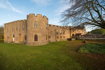 The exterior view of Taunton Castle on a sunny day.