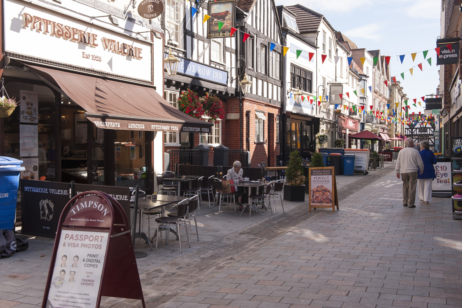 A bustling street in Salisbury centre with cafes, shops and restaurants.