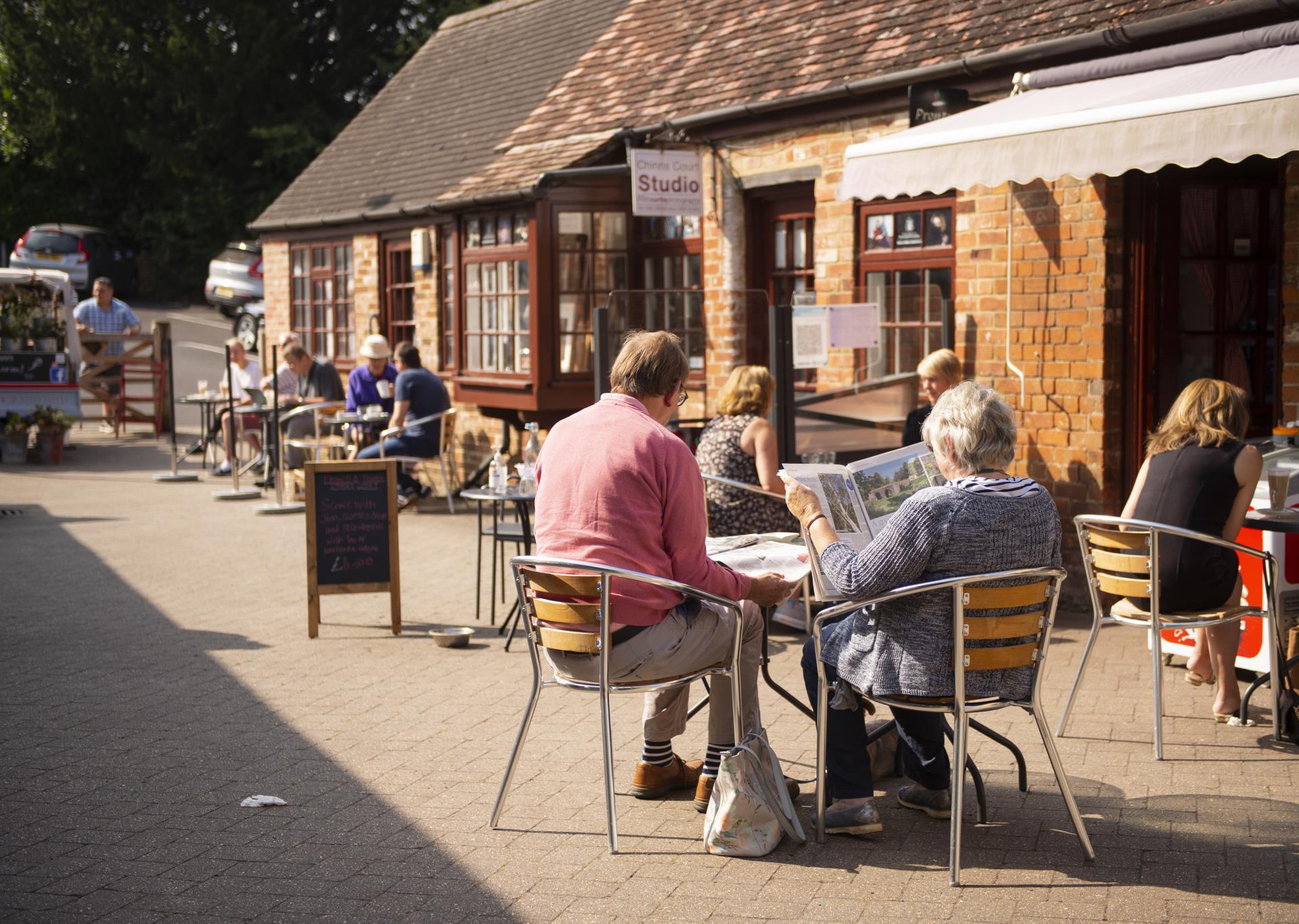 people sitting outside at tables