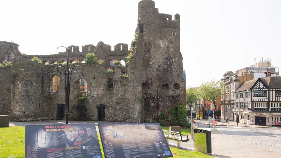 a stone castle with a sign on it