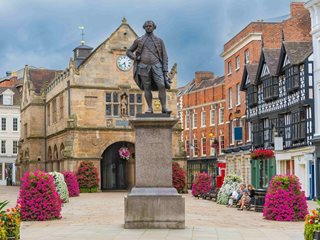 a statue of a person in front of a building