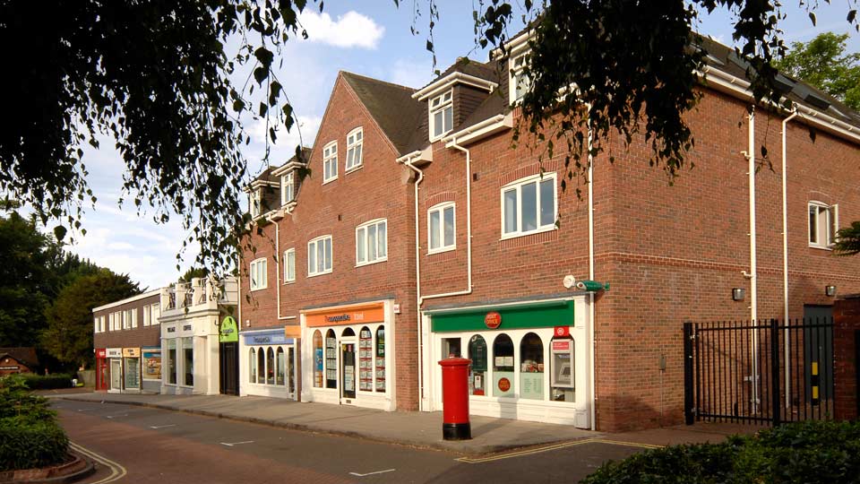 a brick building with a red post