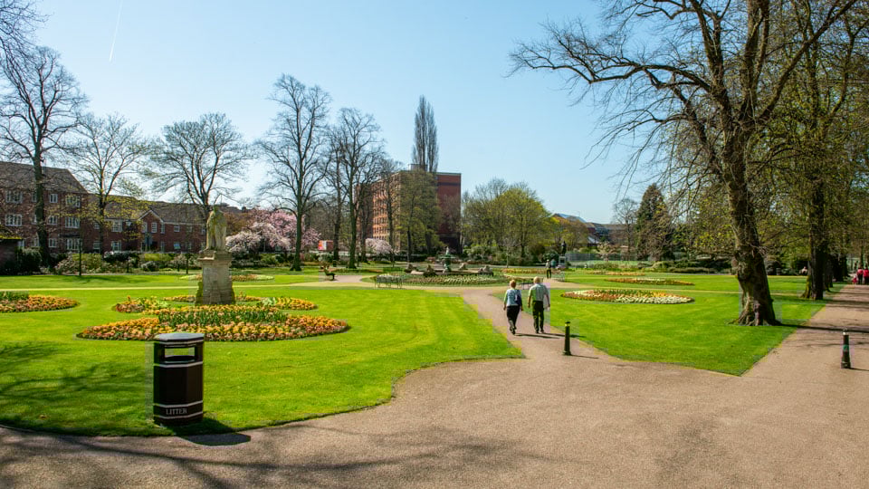 a park with people walking
