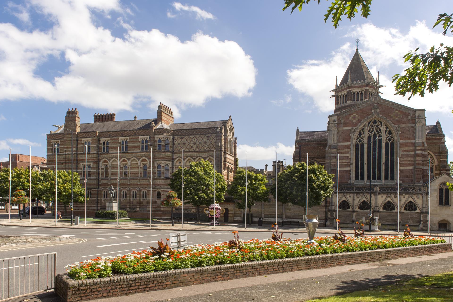 a large building with a garden in front of it