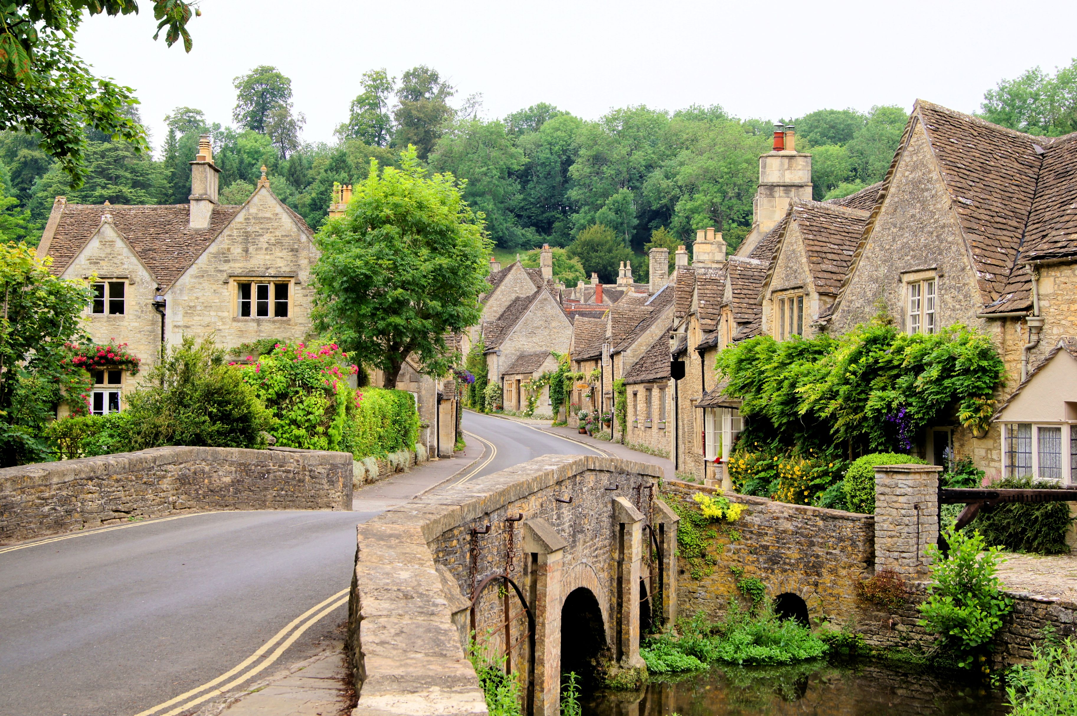 Old houses in Castle Combe, England - a view of the Cotswolds over a river