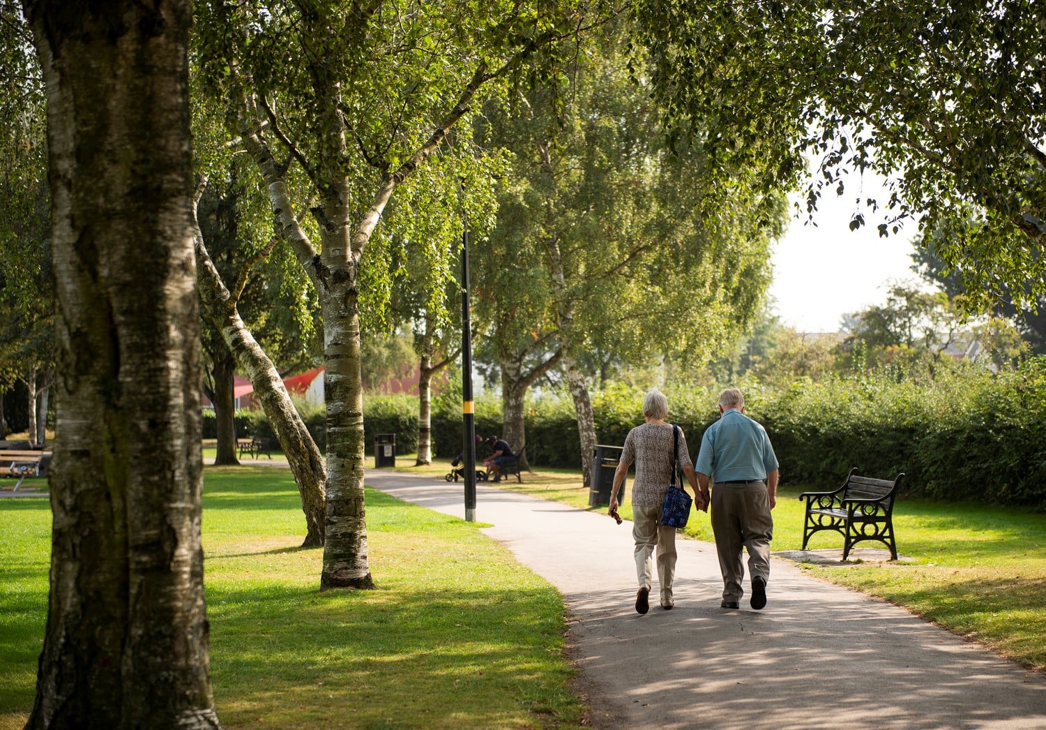 Two retired men enjoy a leisurely stroll through a park in Shirley.
