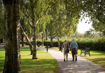 Two retired men enjoy a leisurely stroll through a park in Shirley.