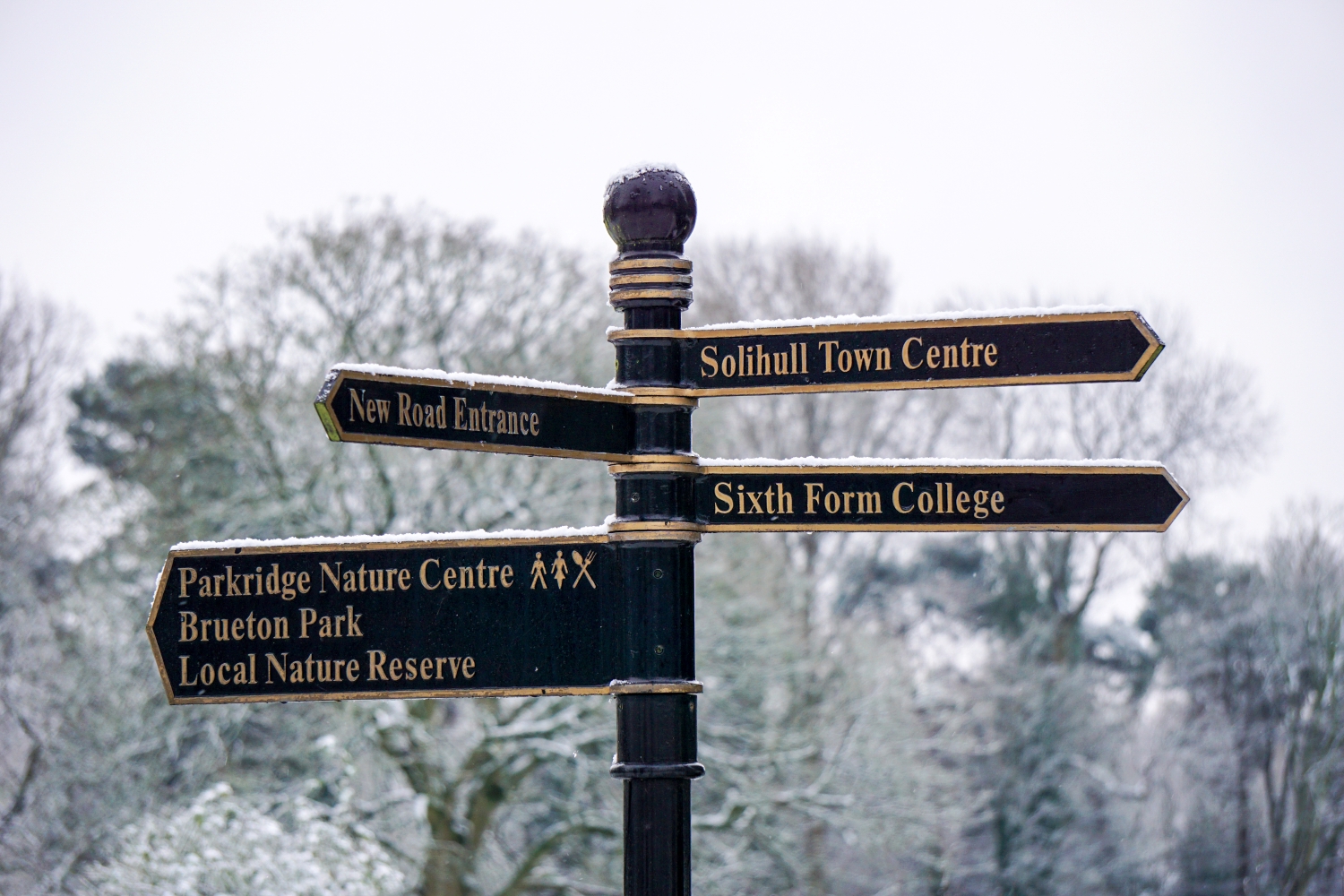 A street signpost with directing to several local attractions in Solihull.