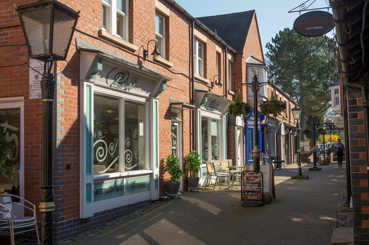A row of shops, businesses, and restaurants line a street in Tettenhall village centre.