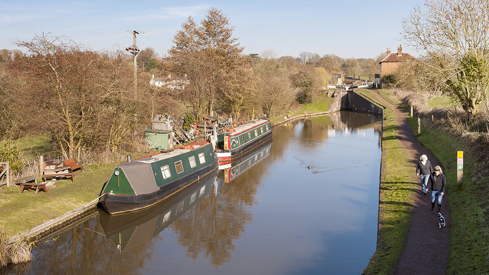 a couple of boats are parked on the side of a river