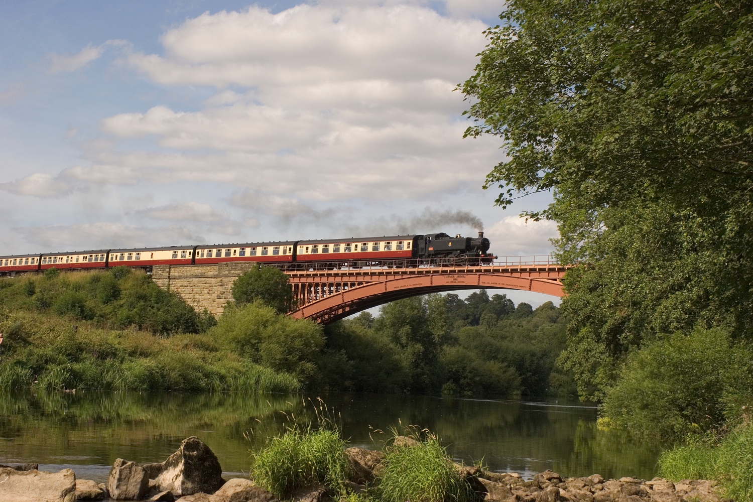 A steam train crossing the Victoria Bridge over the River Severn in Worcestershire.