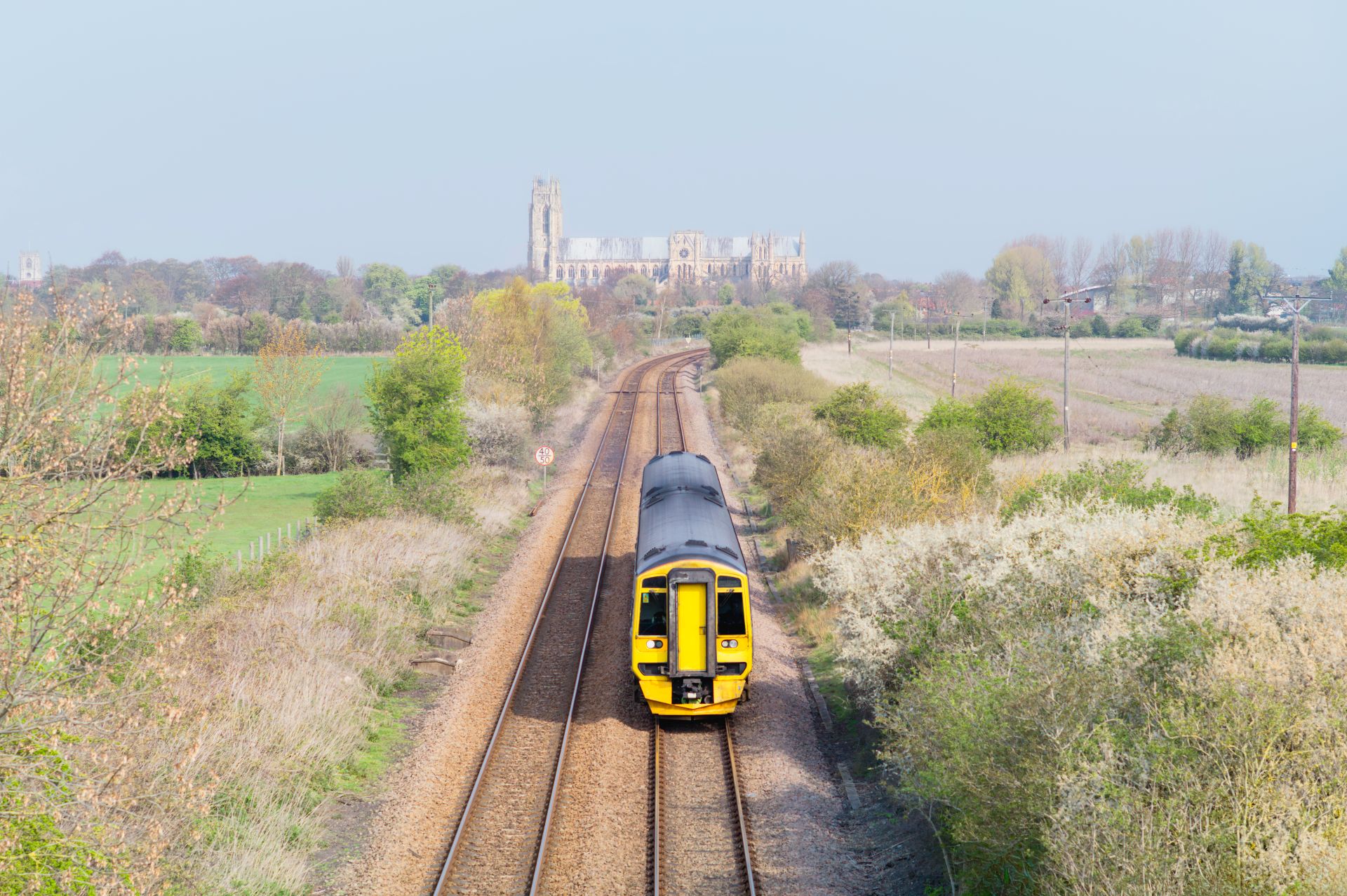 a train travels down the tracks towards Beverley Minster