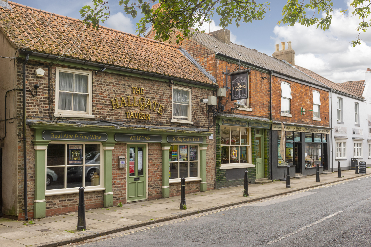 A row of pubs, shops, and local businesses on a street in Cottingham.