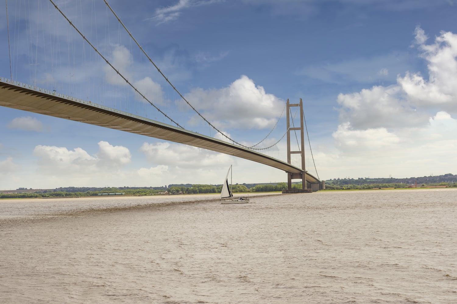 A boat travels under Humber Bridge near Kingston upon Hull.