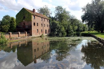 a brick building next to canal