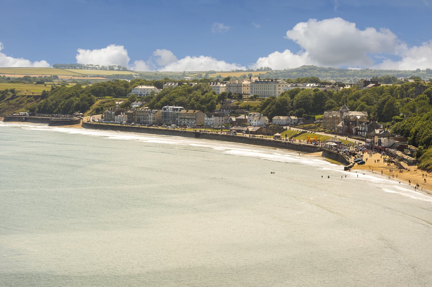 An aerial view of Filey town and beach on a sunny day.