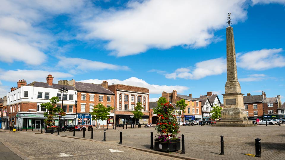 a street with buildings and a statue