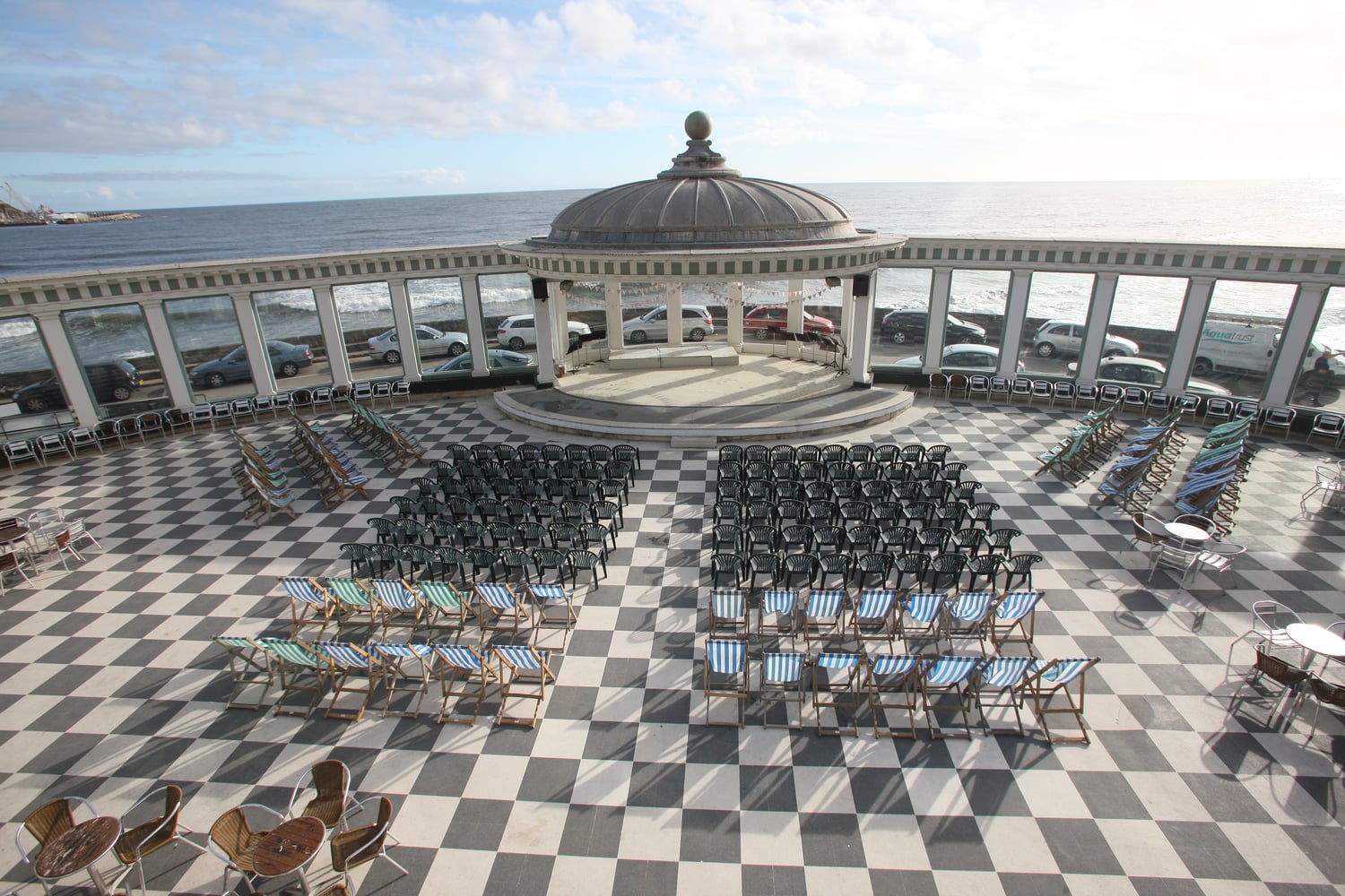 Scarborough Spa Pavillion with its chess board patio, setup with rows of chairs facing out to sea.