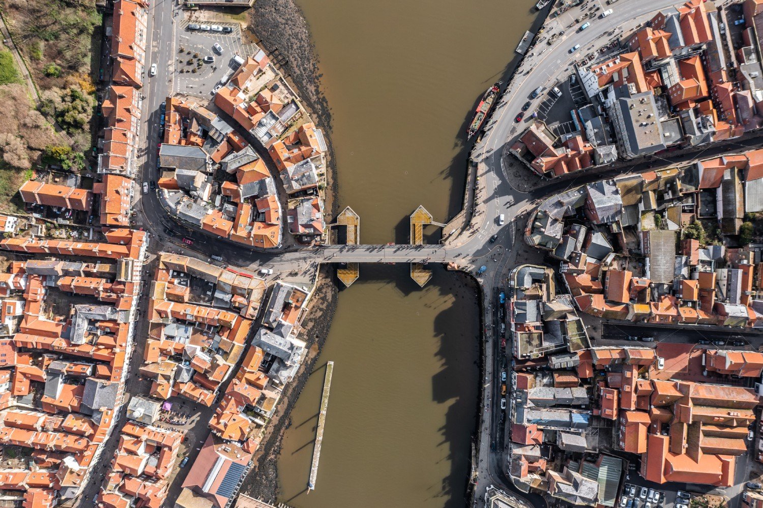 Aerial view of Whitby, showing both sides of town and the central swing bridge