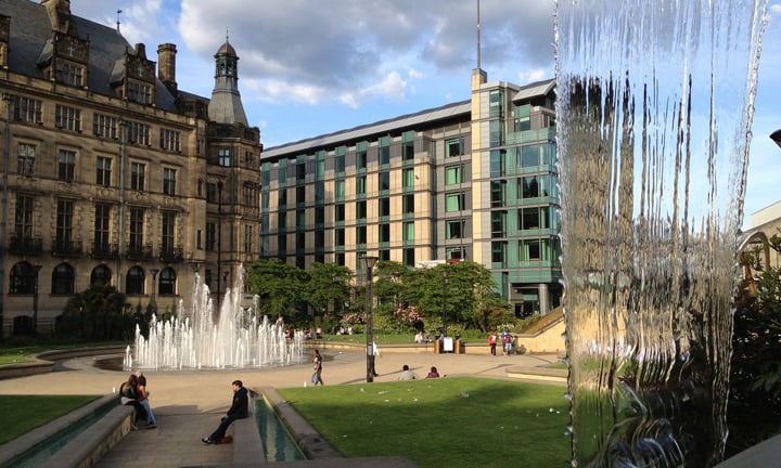 a fountain in a courtyard in front of a building