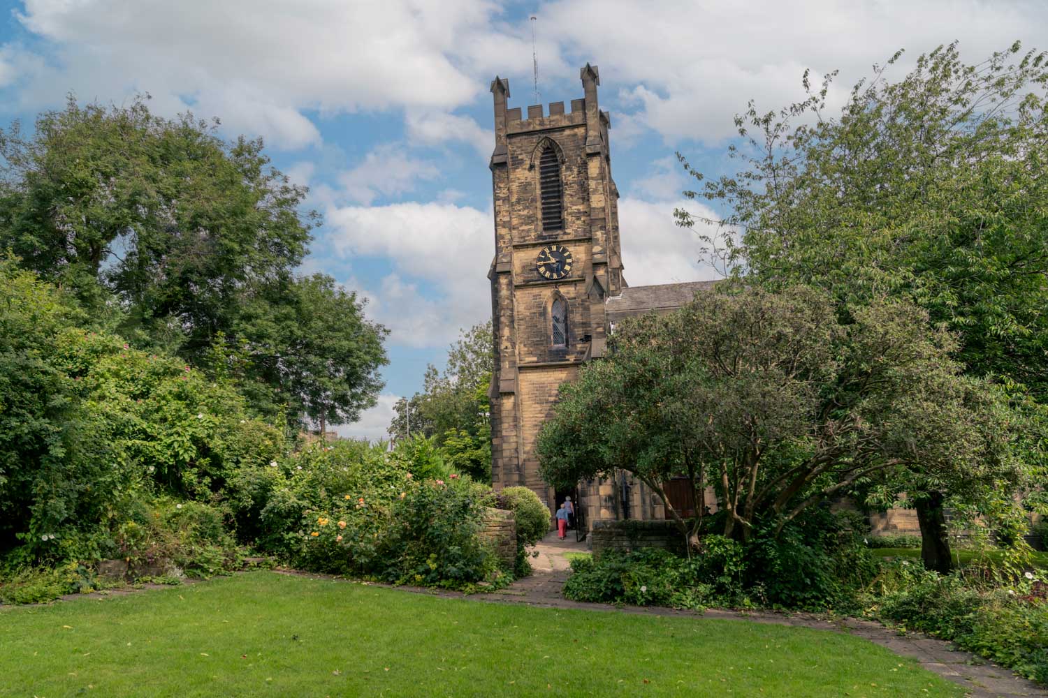 a clock tower behind trees