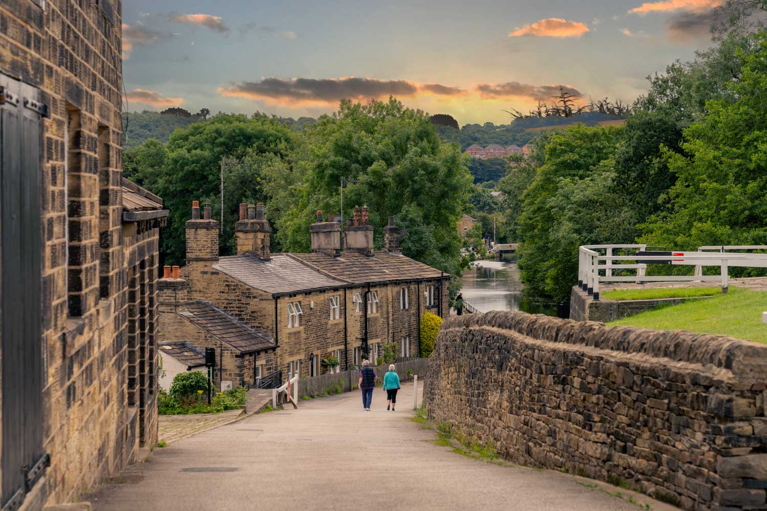 a stone wall with buildings and trees
