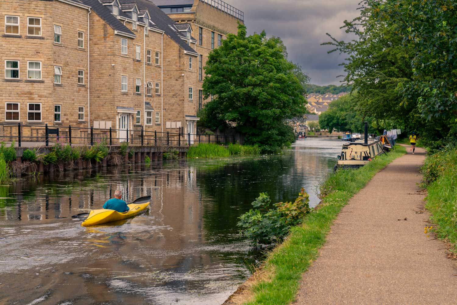 a flooded canal with buildings and trees