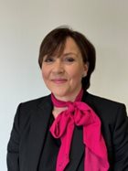 a person wearing a black suit and red scarf