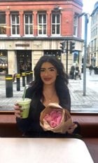 a woman holding a drink and a bag of ice cream