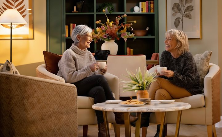 a couple of women sitting on a couch