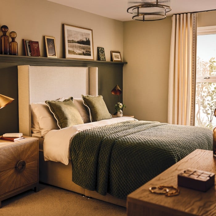 a bed with a green comforter