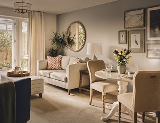 a living room with a round mirror