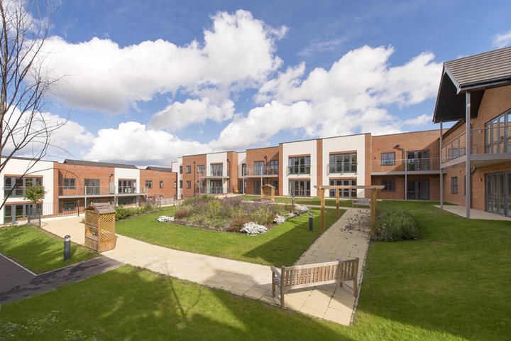 Retirement apartments overlooking a garden at a development by McCarthy Stone.