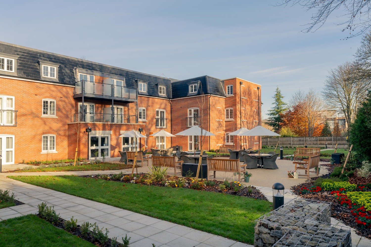 Retirement apartments at a McCarthy Stone development, overlooking a large communal garden.