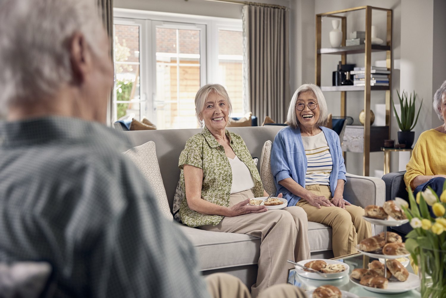 Two retired lady enjoying coffee and cakes at a McCarthy Stone retirement development.