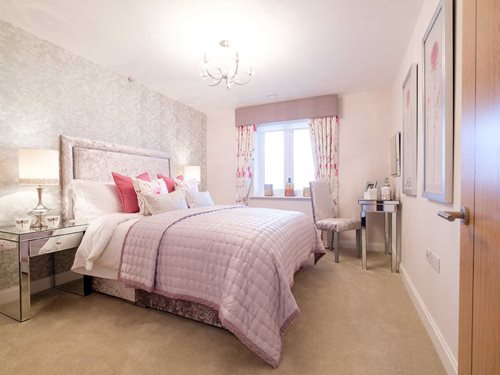 a bedroom with a bed and a desk