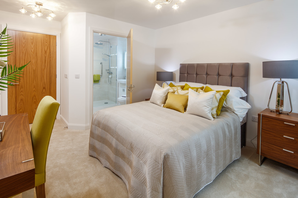 a bedroom with a bed and a desk