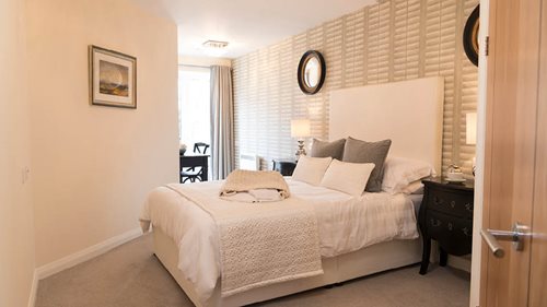 a bedroom with a bed and a lamp