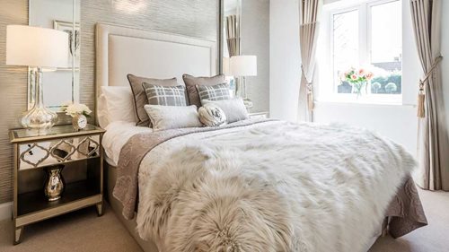 a bed with a white comforter