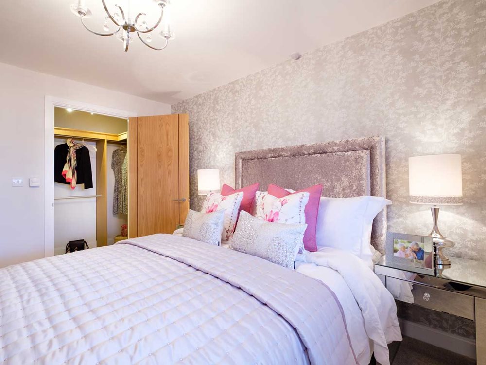 a bedroom with a bed and a lamp