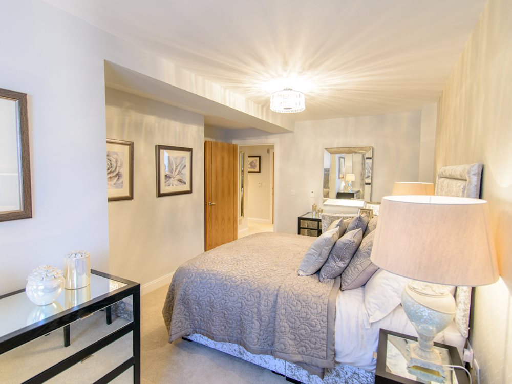 a bedroom with a bed and a lamp