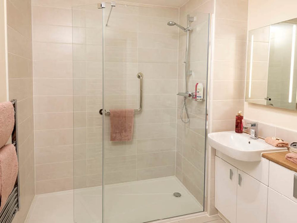 a bathroom with a shower unit and sink