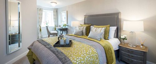 a bed with a table and lamps