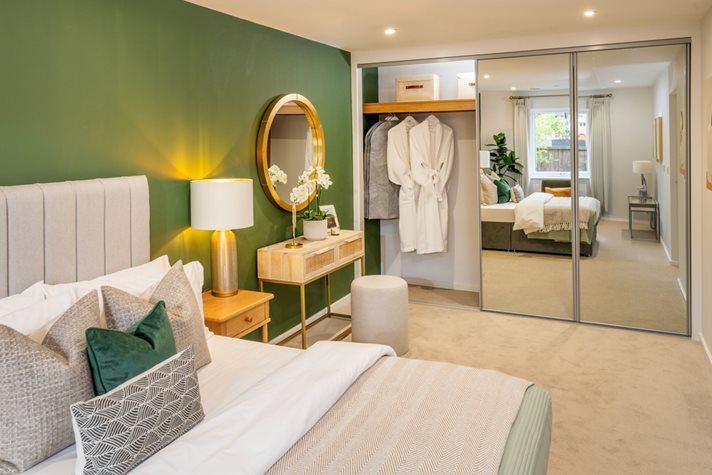 a bedroom with a large mirror