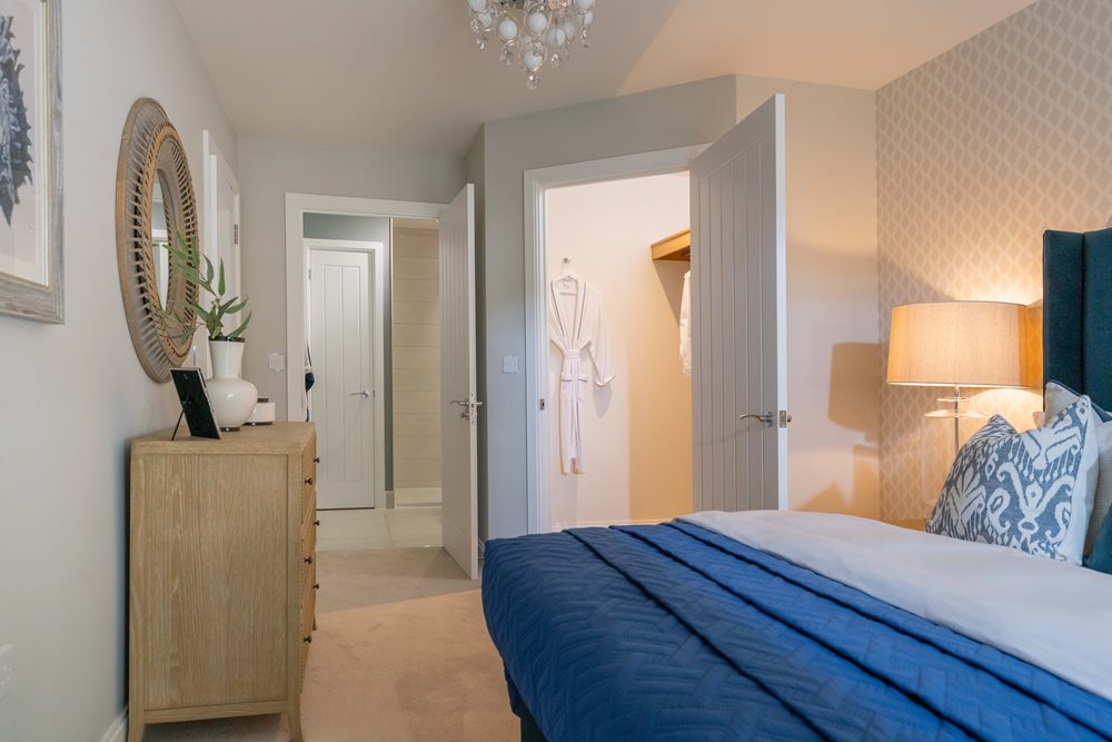 a bedroom with a bed and a mirror
